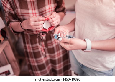 Choosing Dog Collar. Top View Of Woman Wearing Squared Dress Choosing Dog Collar In Pet Shop