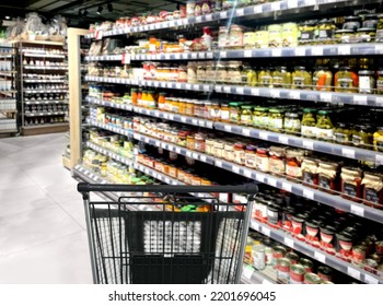 Choosing Food From Shelf In Supermarket,Grocery Stores ,empty Grocery Cart In An Empty Supermarket