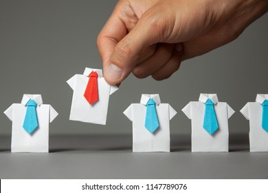 Choosing good employee leader. Man chooses and takes in the hand an employee in shirt and red tie. Staff recruitment. - Shutterstock ID 1147789076