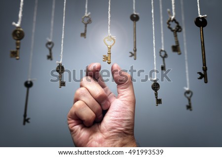 Choosing the key to success from hanging keys concept for aspirations, achievement and incentive