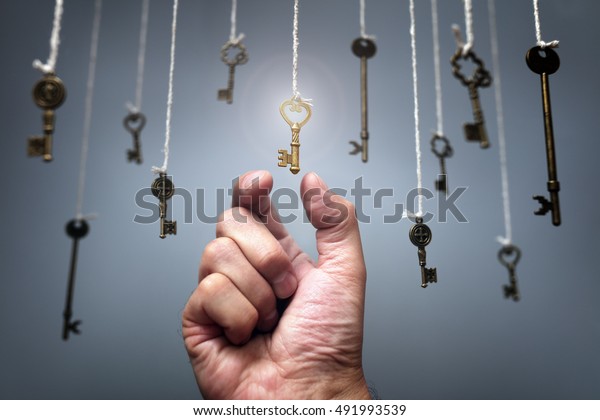 Choosing the key to success\
from hanging keys concept for aspirations, achievement and\
incentive