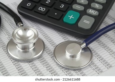 Choosing medical clinic and hospital concept. Cost of medical treatment. Two different stethoscopes on financial data and calculator. - Shutterstock ID 2126611688