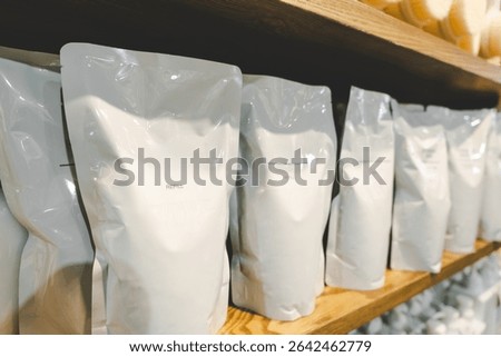 Choosing Refill packet. Zero waste. Reuse reduce recycle concept. refill liquid soap, shampoo and other products. Plastic packaging for refill pouch isolated on white background.
