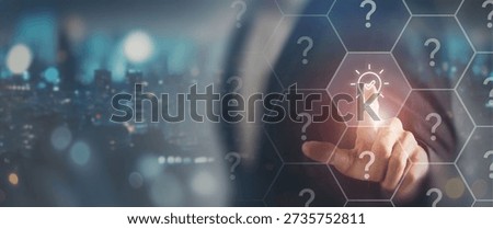 Choosing the right idea or solution concept. Touching a glowing lightbulb icon among question marks, symbolizing idea selection, decision making, innovation and clarity in a complex environment.
