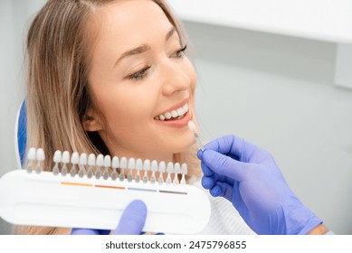 Choosing a shade of dental veneers. Teeth whitening - Powered by Shutterstock