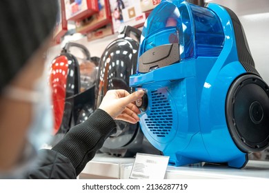 Choosing A Vacuum Cleaner In A Home Appliance Store, A Woman's Hand Checks The Vacuum Cleaner.