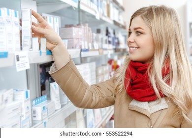 Choosing Wisely. Attractive Cheerful Female Taking A Product From The Store Shelf Smiling While Shopping Consumerism Shopping Choice Beauty Cosmetics Youth Store Supermarket Concept