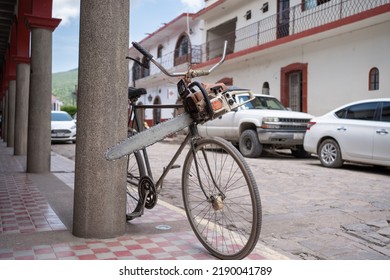 The Chop Saw Is Strapped To The Bike On A Street.