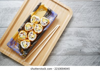 Chop Stick, Sushi Roll With Salmon, Shrimps And Avocado On Table 