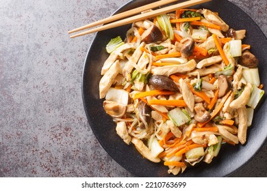 Chop Suey Made With Chicken Quickly Sauteed With Crisp Mixed Vegetables And Bean Sprouts In A Thick Brown Sauce Close-up In A Plate On The Table. Horizontal Top View From Above
