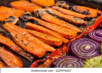 Chopped baked mixed vegetables on tray, selective focus, closeup