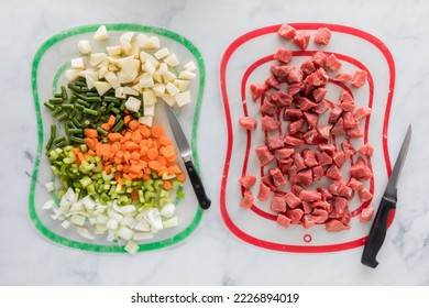 Chopped beef stew ingredients on different mats to prevent cross contamination.