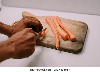 Chopped carrots on a wooden cutting board surrounded by a variety of fresh vegetables, symbolizing World Vegan Day and promoting healthy, plant-based eating - Powered by Shutterstock