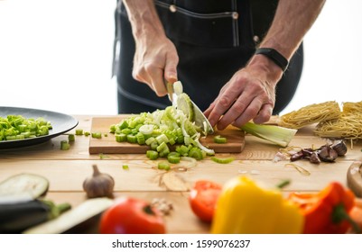 Chopped celery and vegetables on a wooden table. View from above - Powered by Shutterstock