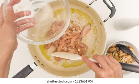 Chopped Chicken Meat Close Up On Frying Pan Directly From Above. Pasta With Chicken, Mushrooms, And Alfredo Sauce Recipe