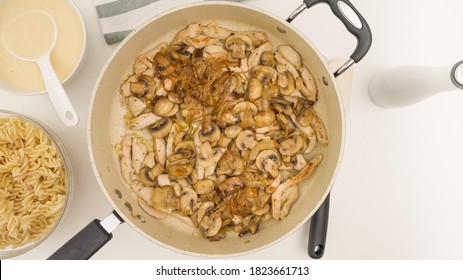 Chopped Chicken Meat And Chopped Mushrooms Close Up On Frying Pan Directly From Above. Pasta With Chicken, Mushrooms, And Alfredo Sauce Recipe