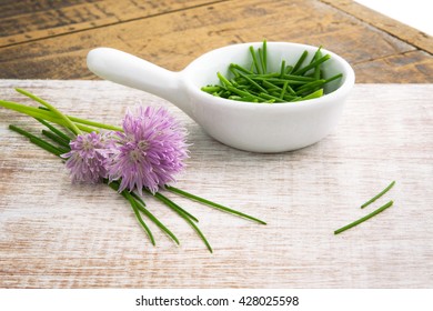 Chopped Chives With Flowers Window Lit For Soft Focus On Wood Grain