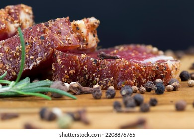Chopped dried meat with spices and herbs, sliced meat on a board with rosemary - Shutterstock ID 2208876765
