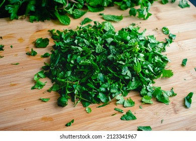 Chopped Fresh Herbs on a Bamboo Cutting Board: A pile of chopped mint, cilantro, and parsley on a wood cutting board - Powered by Shutterstock