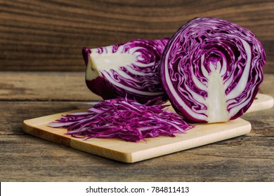 Chopped fresh red cabbage on cutting board to shredded with knife kitchen on wood table with copy space. Prepare sliced vegetable for cooking purple cabbage salad or coleslaw. Homemade food concept. - Powered by Shutterstock