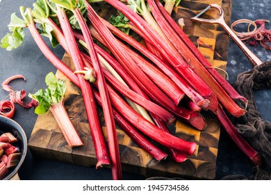 Chopped fresh rhubarb on dark stone background. Top view. Free copy space - Shutterstock ID 1945734586