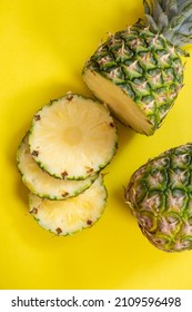 chopped fruit pineapple top view. Fresh pineapple fruit on a yellow background