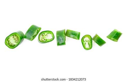 Chopped green chilli pepper isolated on a white background, top view. Sliced jalapeno peppers.