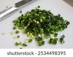 Chopped green onions on a cutting board