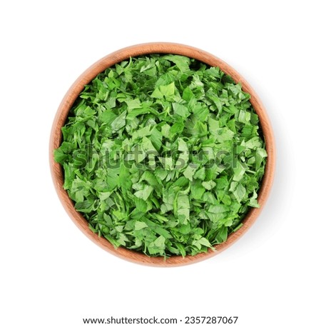 Chopped parsley leaves in wooden bowl isolated on white, top view