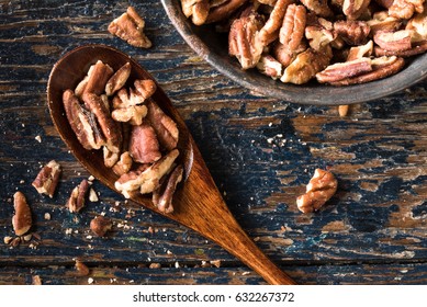 Chopped Pecans on a Wood Spoon