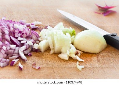 Chopped red and brown onions on a wooden surface