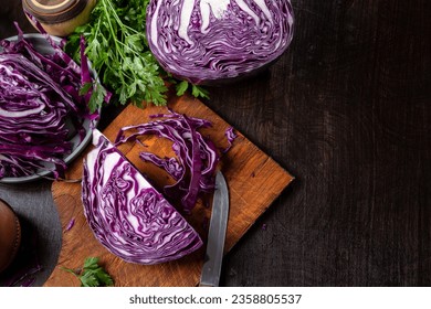 Chopped red cabbage close-up on a cutting wooden board in the kitchen. Copy space. - Powered by Shutterstock