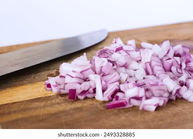 Chopped red onion and knife on wooden cutting board - Powered by Shutterstock