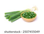 Chopped spring onion in wooden bowl with fresh green onion isolated on white background.