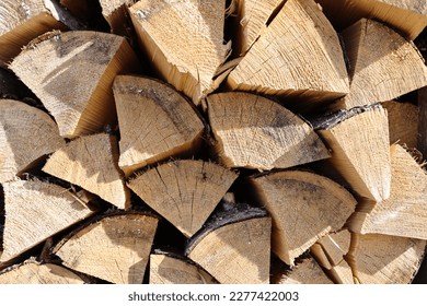 Chopped and stacked up dry firewood at the countryside. Stock pile of timber, chopped down trees . - Shutterstock ID 2277422003