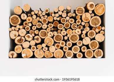 Chopped stacked firewood on a shelf in white wall.  - Powered by Shutterstock