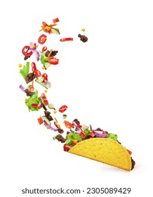 Chopped toppings flying out of a Mexican taco isolated on a white background