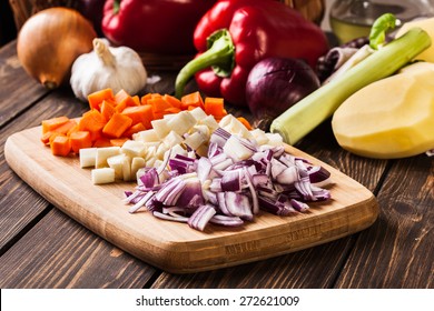 Chopped Vegetables: Carrots, Parsley And Onion On Cutting Board