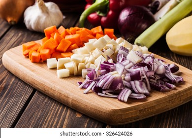 Chopped Vegetables: Carrots, Parsley And Onion On Cutting Board