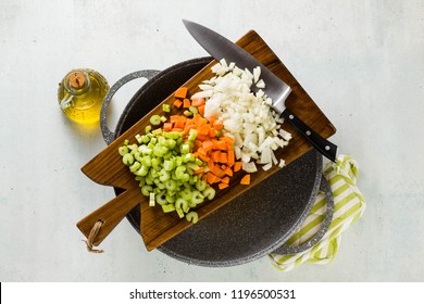 chopped vegetables and a chef's knife on a wooden cutting board. Basic cutting for restaurants or home cooking. and wok - Powered by Shutterstock
