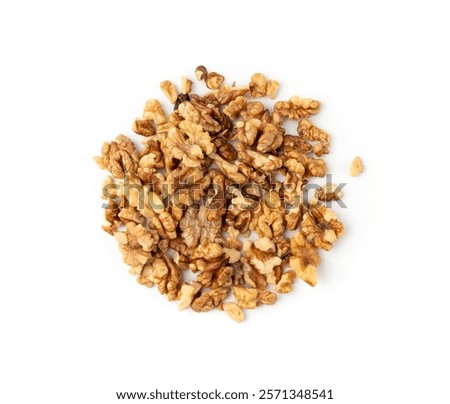 Chopped wallnut , broken roasted walnuts powder, heap of nuts crumbs, whole kernel pieces, fractions, powder top view on white background