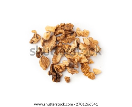 Chopped wallnut , broken roasted walnuts powder, heap of nuts crumbs, whole kernel pieces, fractions, powder top view on white background