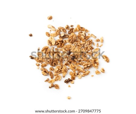 Chopped wallnut , broken roasted walnuts powder, heap of nuts crumbs, whole kernel pieces, fractions, powder top view on white background