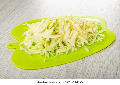 Chopped White Cabbage On Green Cutting Board On Wooden Table