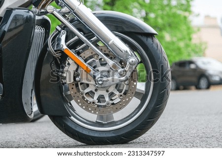 Chopper motorcycle wheel close up. Brake disc on a wheel from a motorcycle close up. Motorcycle front wheel with spokes and alloy wheels with brake and clutch. Motorcycle in close-up details.