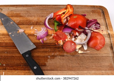 Chopping Board With Knife And Food Scraps For The Compost Bin