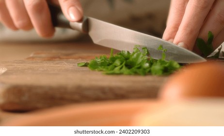 Chopping Fresh Parsley on Wooden Board, Cooking Action. Close-up, shallow dof. - Powered by Shutterstock