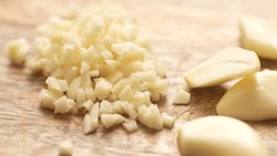 Chopping Garlic With Halves On A Cutting Board. Close-up, Shallow Dof.