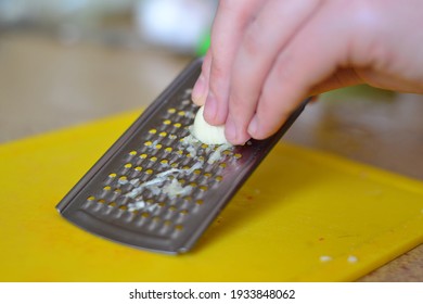 Chopping Garlic On A Fine Grater