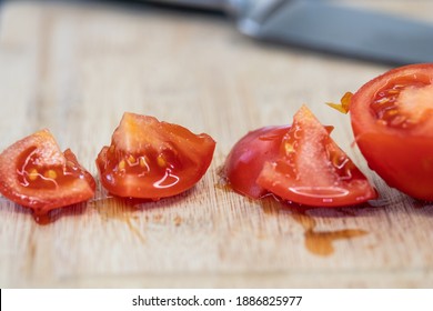 Chopping tomato on wooden table